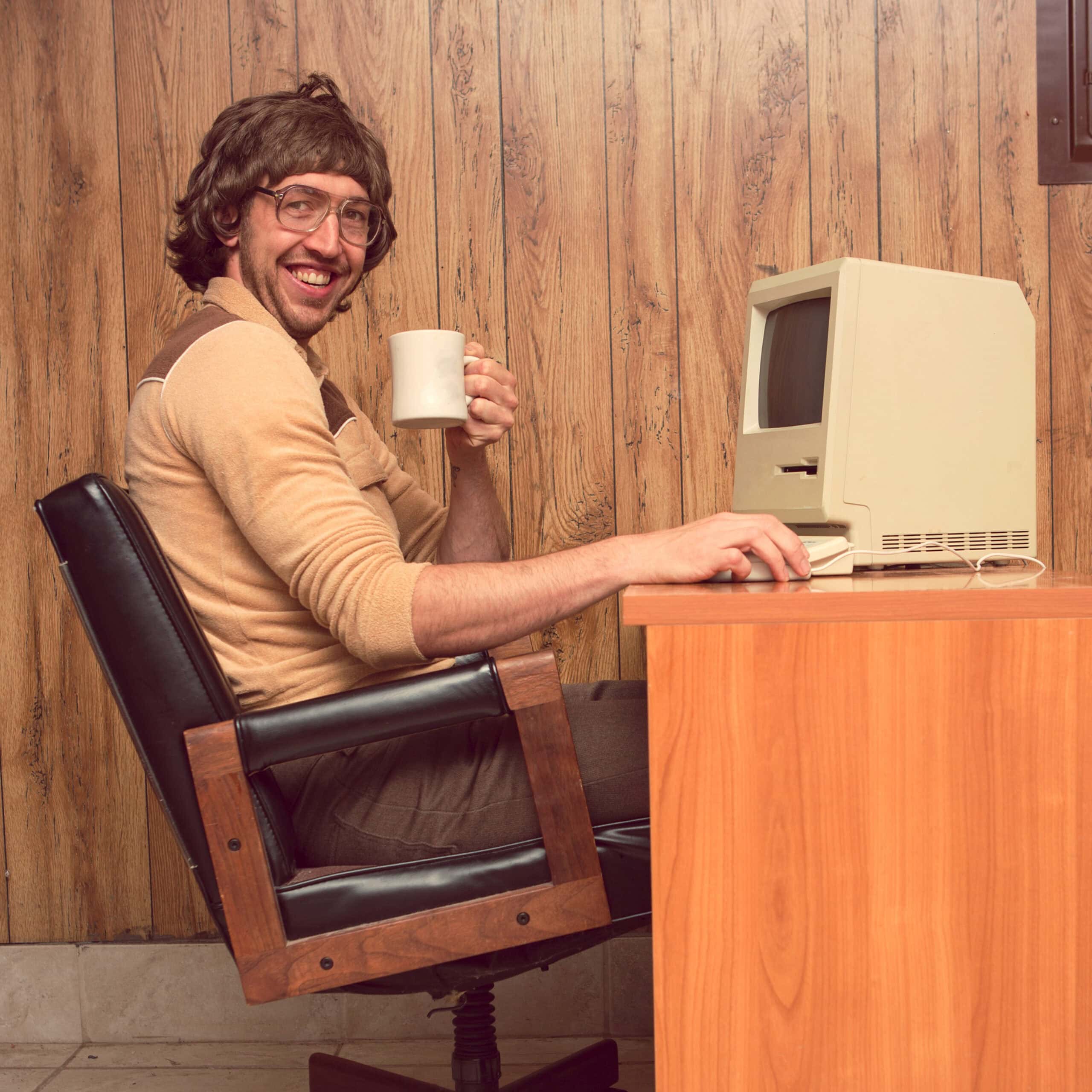 Funny 1980s Computer man at desk with coffee