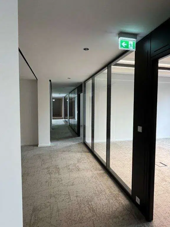 Langer Büroflur mit Glaswänden